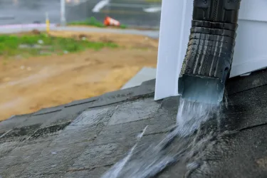 Heavy rain draining through a gutter system