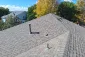 Completed architectural shingle roof with several planes and roof vents